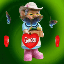 a figurine of a woman holding a red heart that says garden