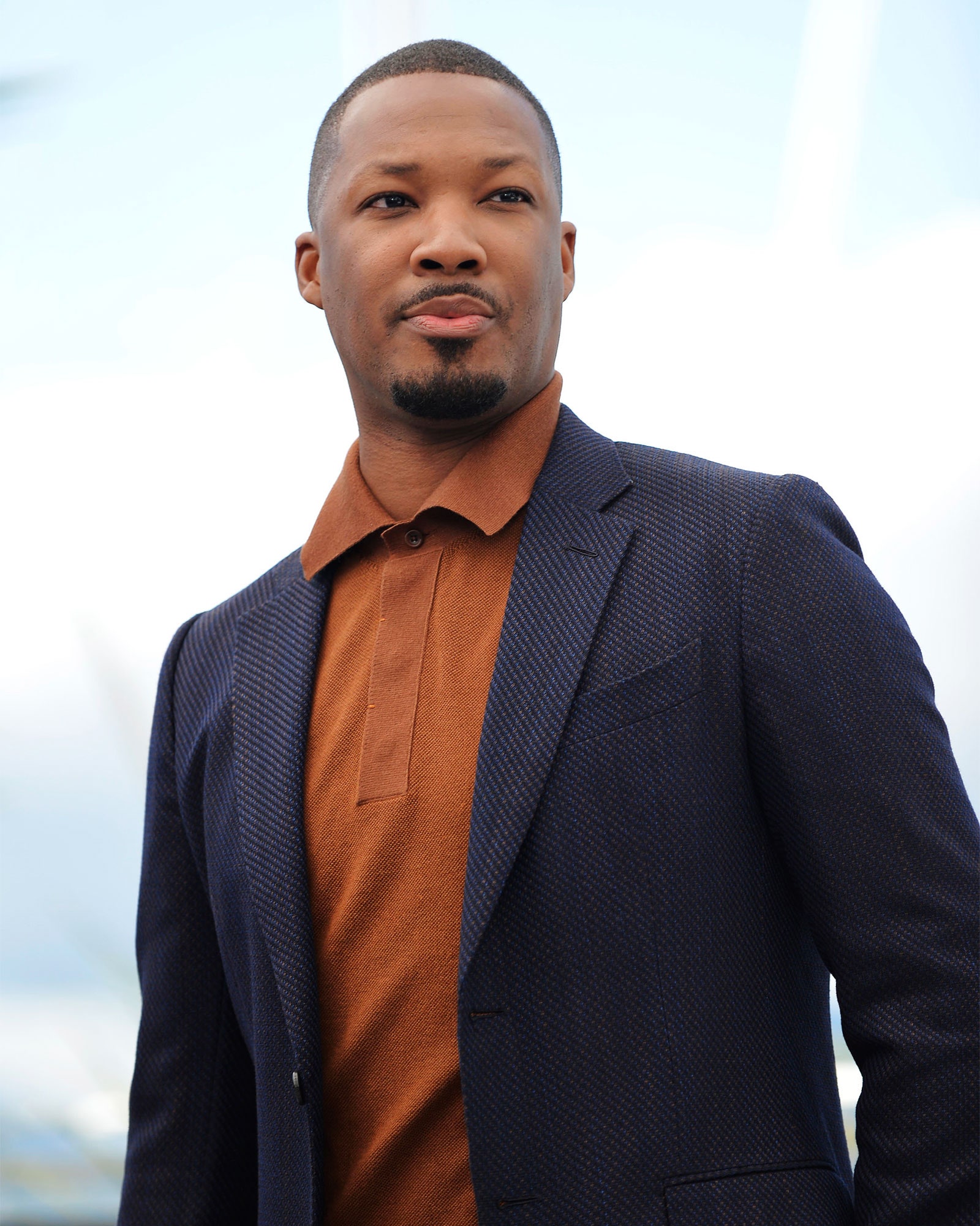 Image may contain Human Person Corey Hawkins Clothing Suit Overcoat Apparel and Coat