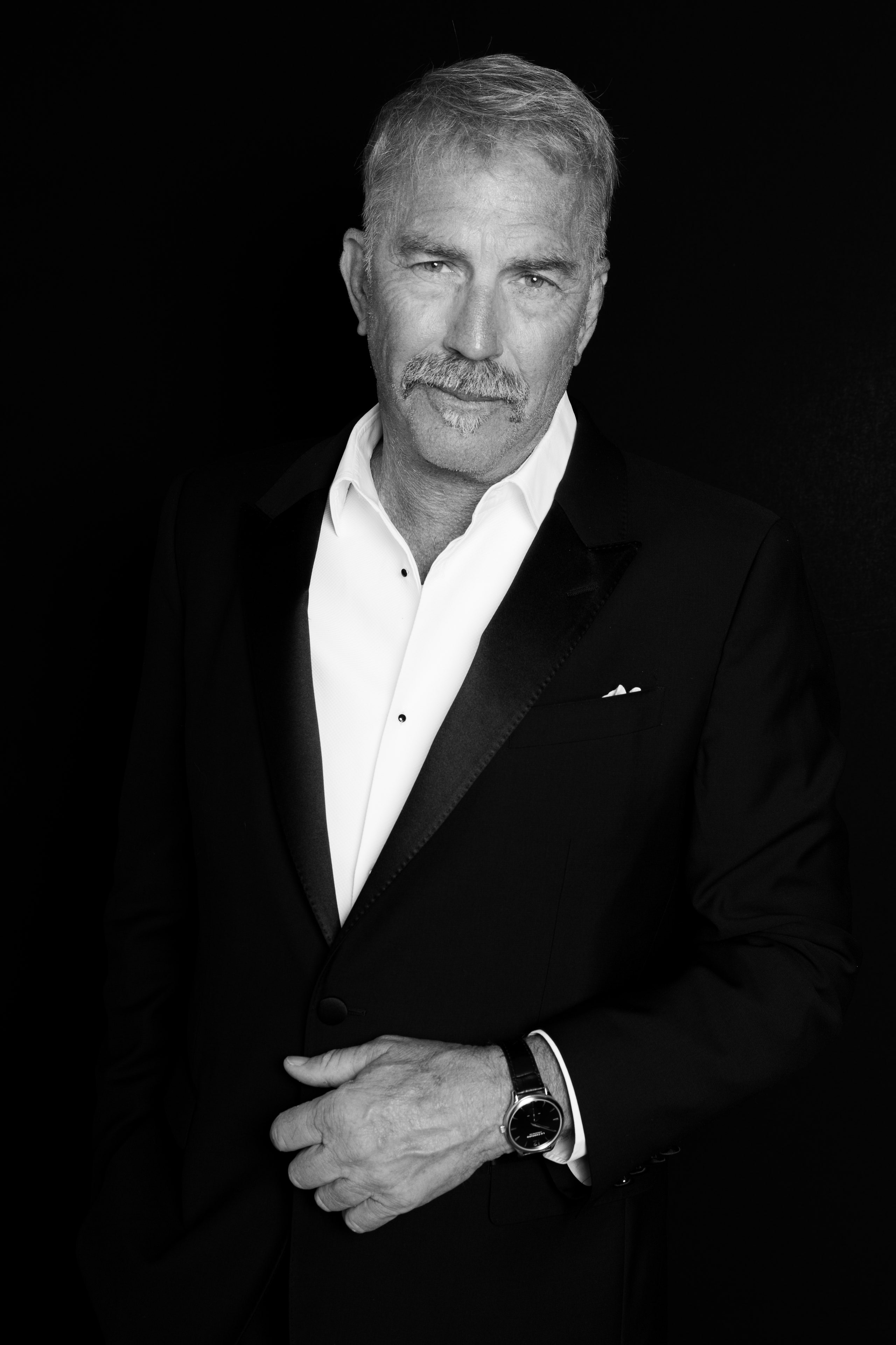 Image may contain Kevin Costner Clothing Formal Wear Suit Face Head Person Photography Portrait and Body Part