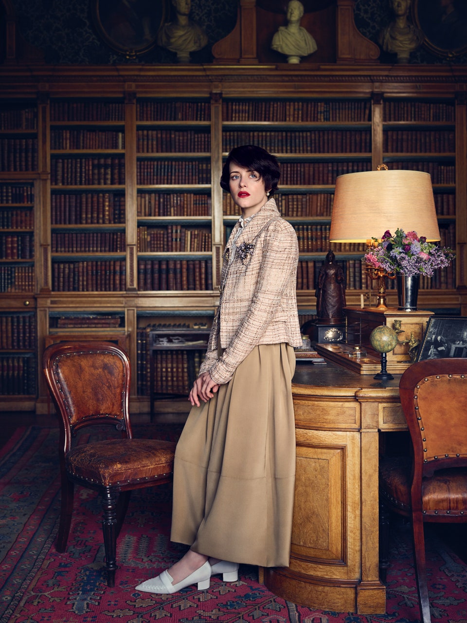 Image may contain Claire Foy Furniture Chair Human Person Home Decor Room Indoors Lamp Table Lamp and Clothing