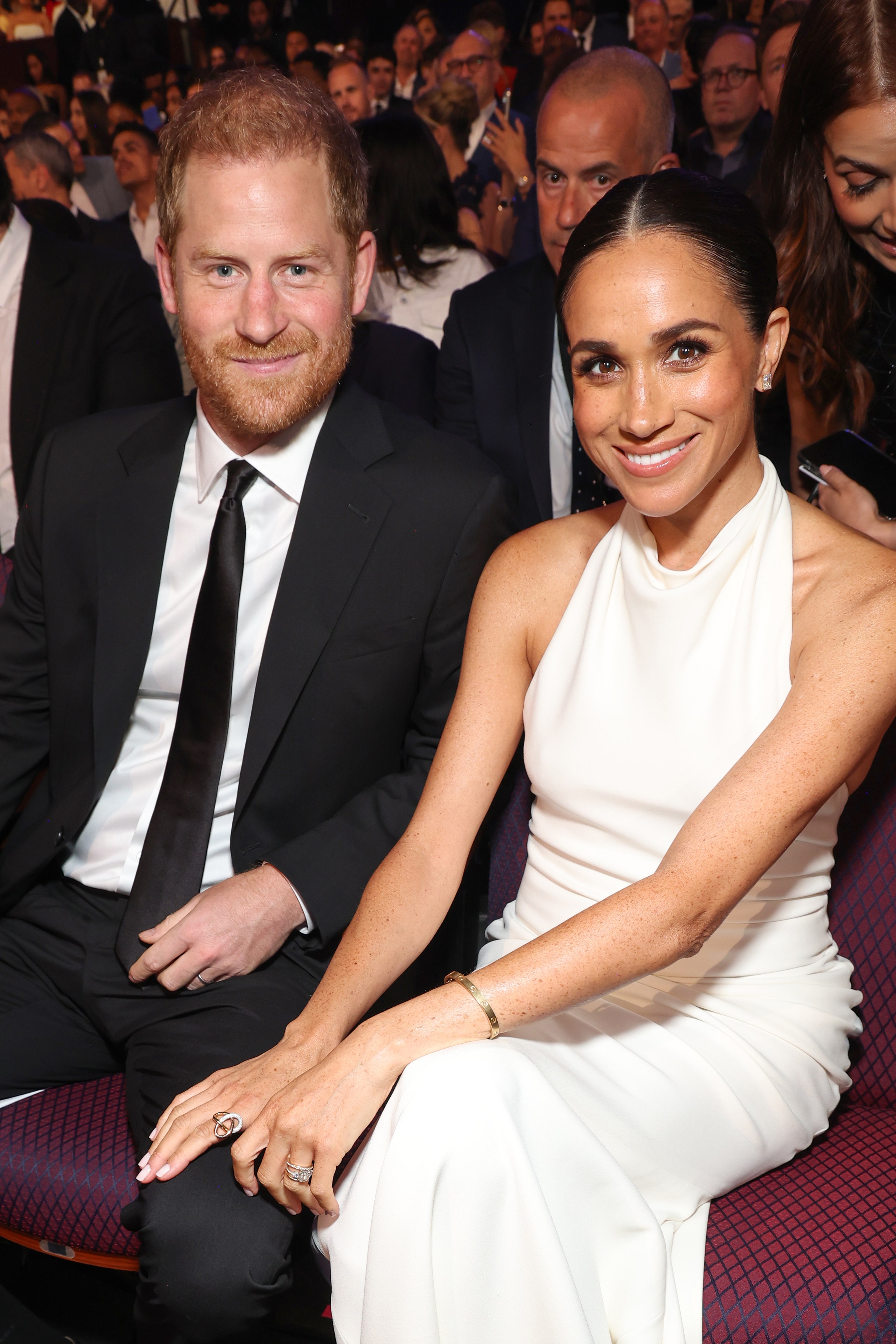 Image may contain Meghan Duchess of Sussex Prince Harry Duke of Sussex Fashion Electronics Mobile Phone and Phone