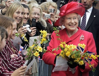 Image may contain Elizabeth II Human Person Plant Tie Accessories Accessory Flower Blossom and Flower Bouquet