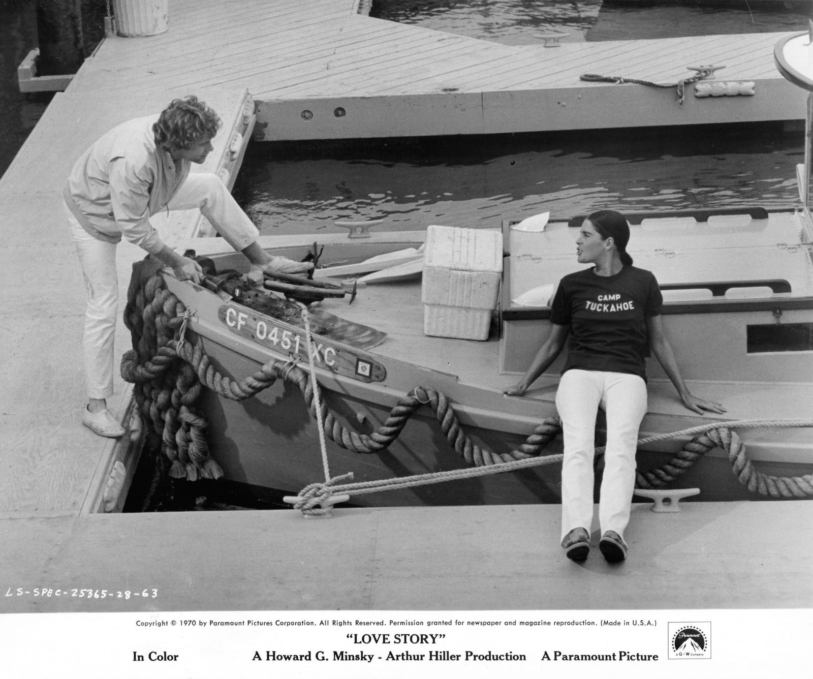 Ryan O'Neal at boat dock with Ali MacGraw in a scene from the film 'Love Story' 1970.