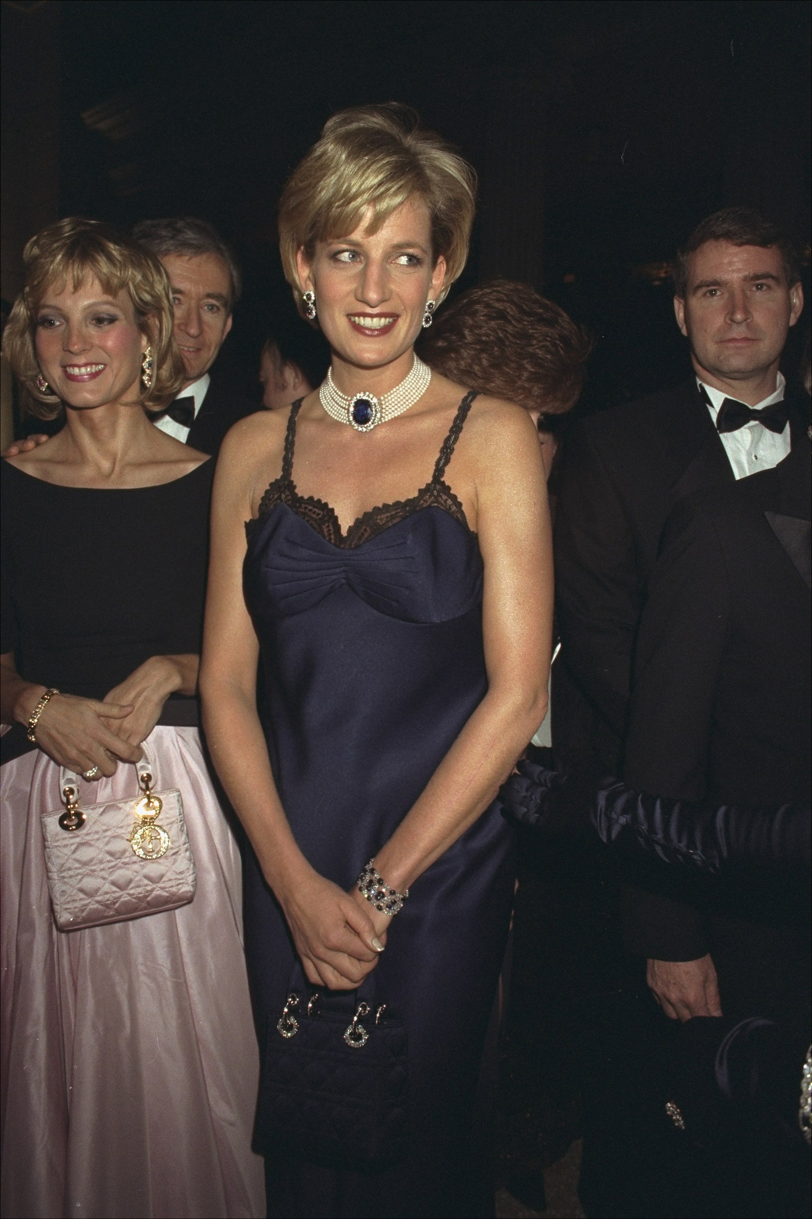 Image may contain Diana Princess of Wales Human Person Bernard Arnault Suit Coat Clothing Overcoat Apparel and Tie