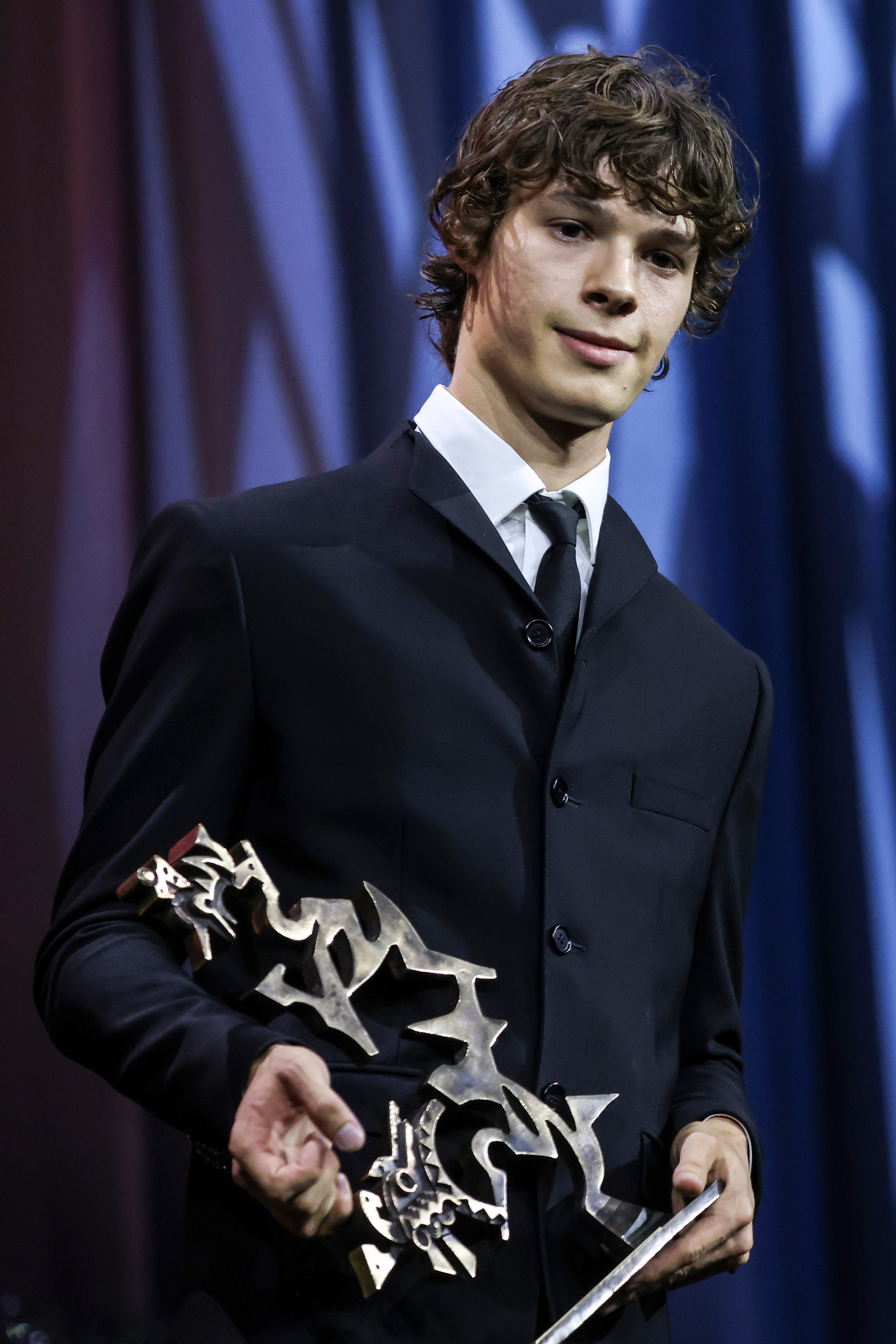 Paul Kircher poses with the Marcello Mastroianni Award as Best Young Actor for the movie “And Their Children After Them”...