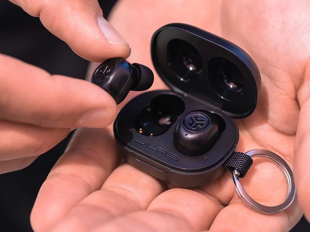 JLab JBud Mini Earbuds in the palm of a person's hands