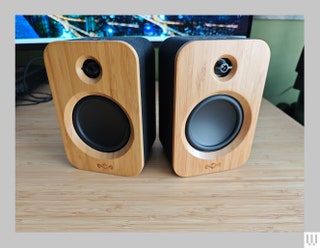 Black rectangular speakers with wooden front panels