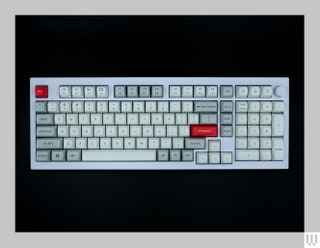 White computer keyboard with white grey and red keys