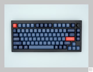 Black computer keyboard with blue and red keys