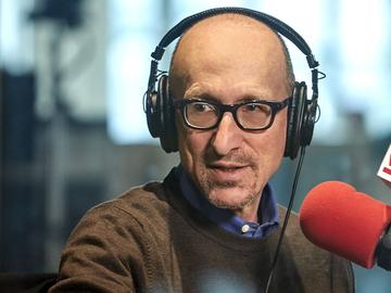 Host Brian Lehrer speaking into a microphone