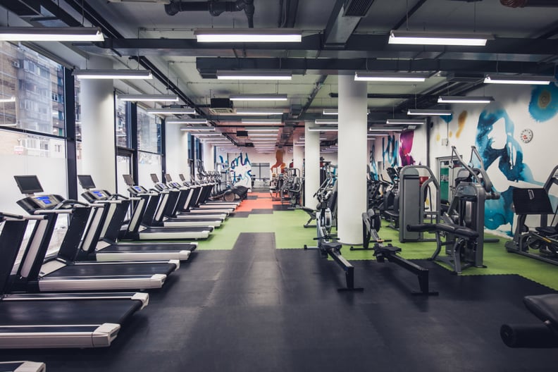 Large group of exercise machines in an empty gym.