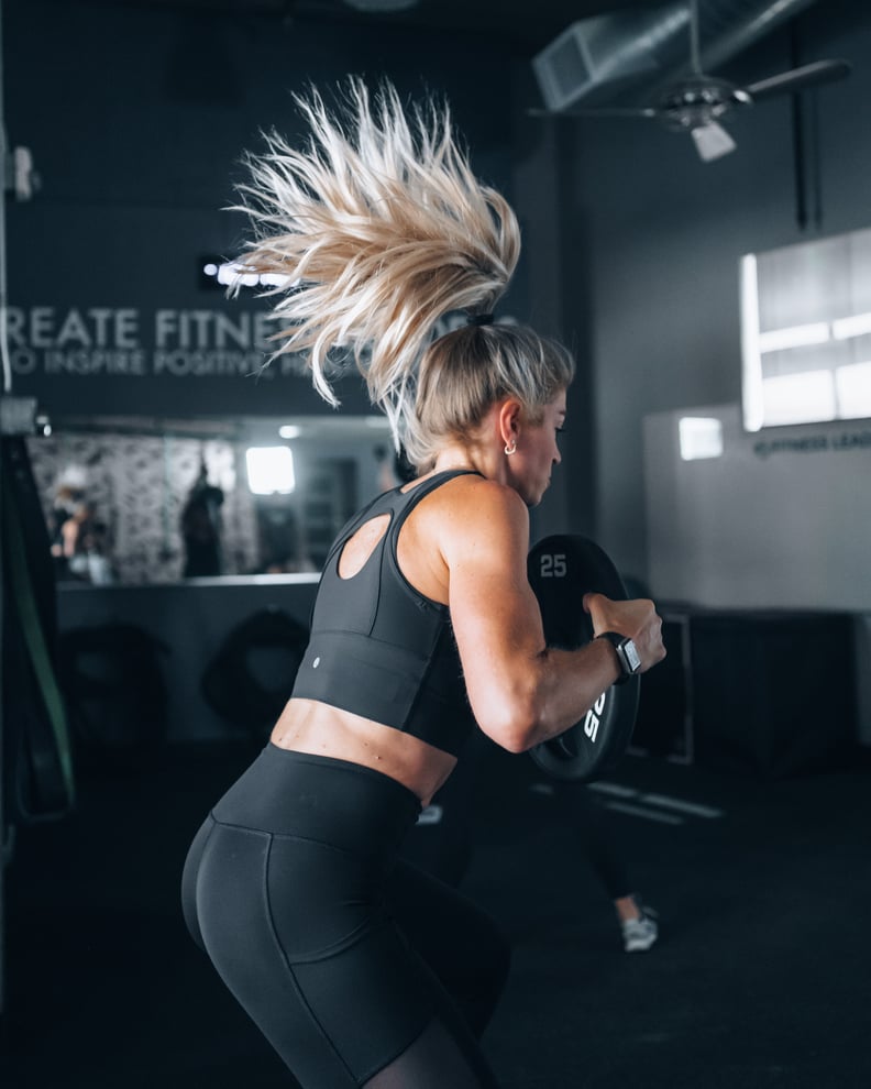 woman lifting weights, will have sore muscles after workout