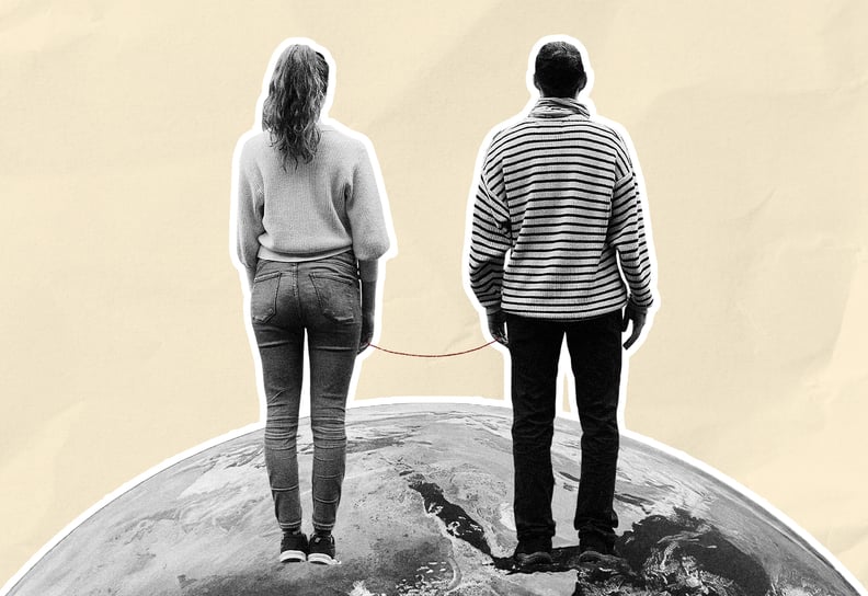Woman and man chained to eachother standing on an image of the world in black and white