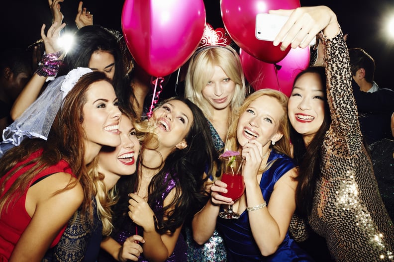 A group of women laughing, drinking and celebrating at hen do