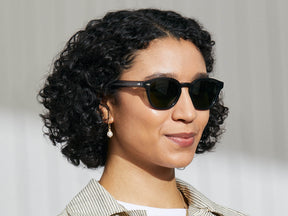 Model is wearing The LEMTOSH SUN in Grey in size 49 with G-15 Glass Lenses