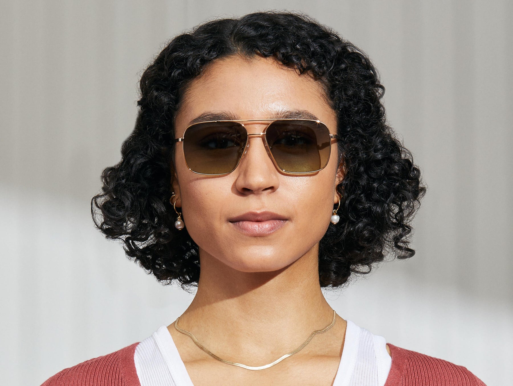 Model is wearing The SHTARKER in size 57 in Gold with Forest Wood Tinted Lenses