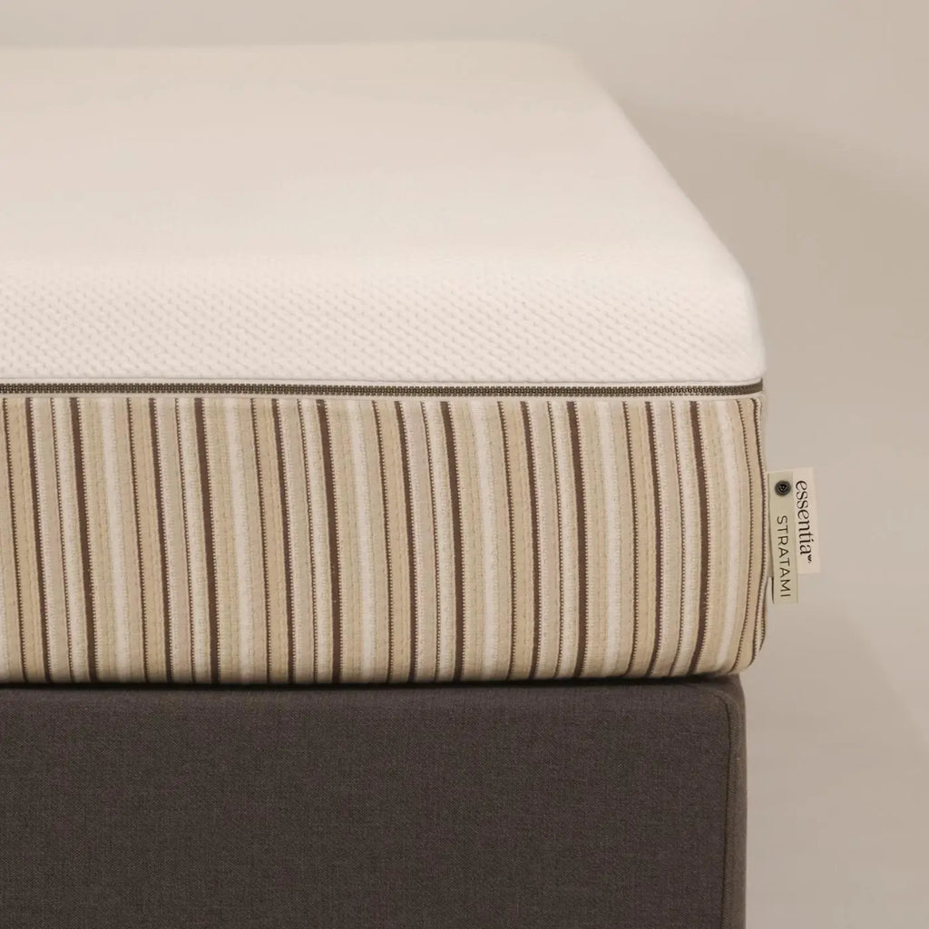 Close up of the corner of an Essentia Stratami organic mattress shown on the Vertebase foundation