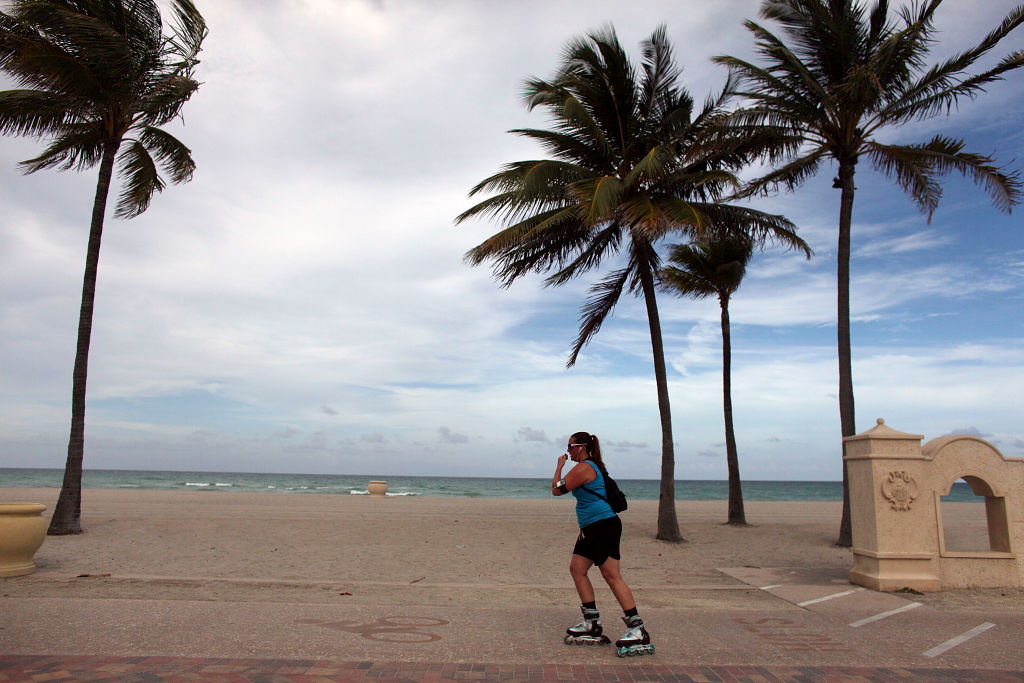 HOLLYWOOD, FL - AUGUST 19: A roller blader passes the empty beach on August 19, 2009 in Hollywood, Florida. An estimated 20.1 million people visited Florida from April through June, a 9.4 percent decrease over the same period last year, Florida's tourism marketing agency reported. (Photo by Joe Raedle/Getty Images)