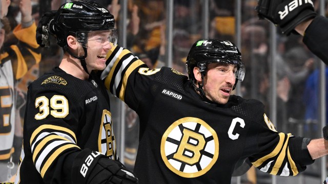 Boston Bruins forwards Morgan Geekie, Brad Marchand