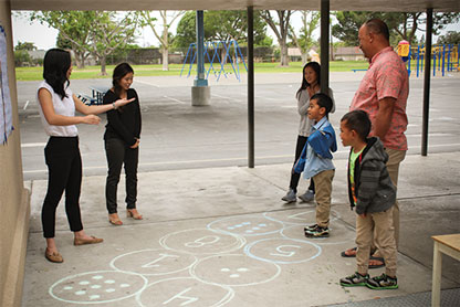 parents and children playing math night game