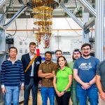 Photo taken at SQMS Quantum Garage at Fermilab. Pictured L-R: Akshay Murthy, associate scientist at Fermilab; Yao Lu, associate scientist at Fermilab; Jason Orcutt, principal research scientist at IBM; Tanay Roy, associate scientist at Fermilab; Andre Vallieres, PhD student at Northwestern University; Silvia Zorzetti, department head, quantum computing co-design and communication at Fermilab; Jacob Hanson-Flores, summer intern at Fermilab; Alessandro Reineri, PhD student at Illinois Institute of Technology; Joey Yaker, PhD student at Northwestern University. (Credit: Dan Svoboda, Fermilab)