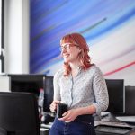 Brand image - Work Life. Woman in a conference room at work in a casual office environment.