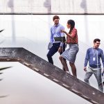 Brand image - Colleagues talking on a staircase.