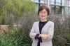 Smiling woman standing in front of plants. says Jung-Ah Lee, professor and associate dean for diversity, equity, inclusion and belonging at UC Irvine’s Sue & Bill Gross School of Nursing.