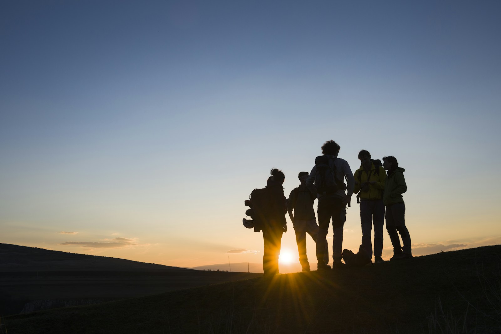 A group of people at sunrise