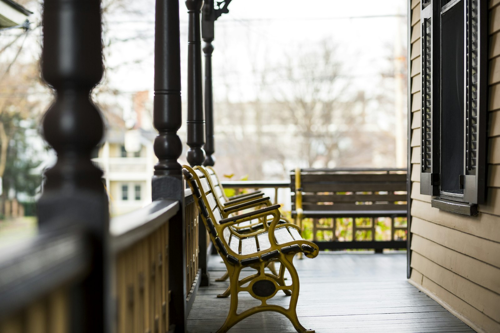 A bench sits on a covered porch