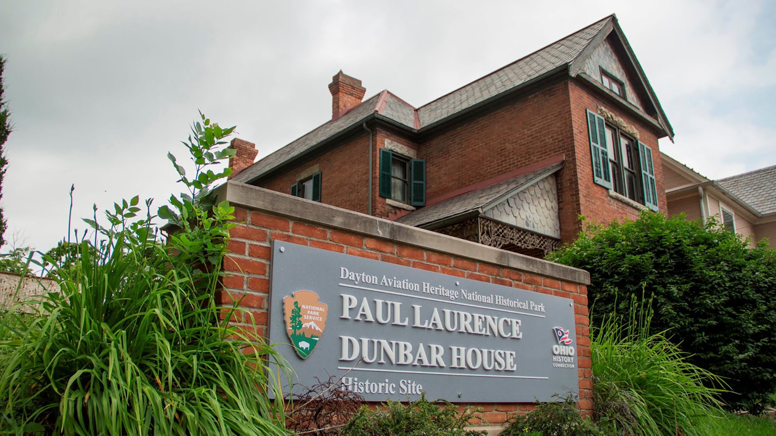 Exterior and sign outside a two-story brick home