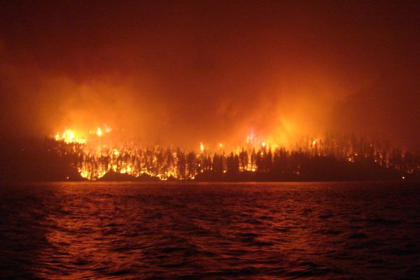 a wildfire as seen across Loon Lake, British Columbia