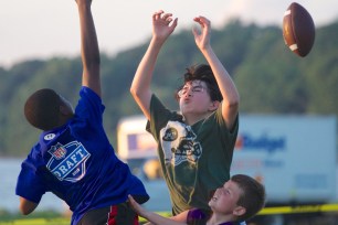 Males need to blow off steam: Boys playing touch football in Irvington while waiting for fireworks to start this past summer.