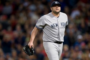 Yankees reliever Joba Chamberlain walks off the mound after being pulled in the team's loss to the Red Sox.
