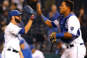 Tim Collins (left) and Salvador Perez celebrate after the Royals beat the Indians