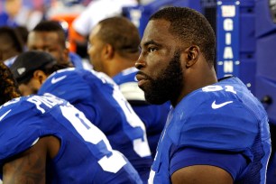 Justin Tuck on Giants sidelines during loss to Broncos