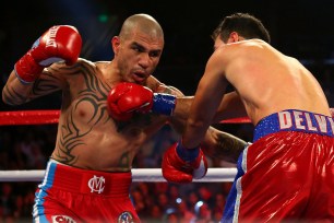 Miguel Cotto throws a punch against Delvin Rodriguez on Saturday night.