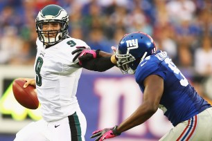Eagles quarterback Nick Foles eludes Giants defensive end Mathias Kiwanuka.