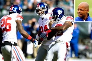 Giants celebrate interception against Eagles. Jerry Reese (inset),