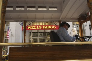 A Wells Fargo Bank sign seen through a motorized cable car in San Francisco.