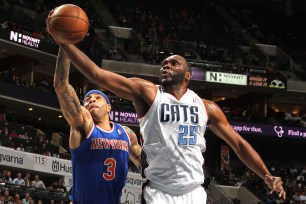 Kenyon Martin of the Knicks goes for a rebound against Al Jefferson of the Bobcats.