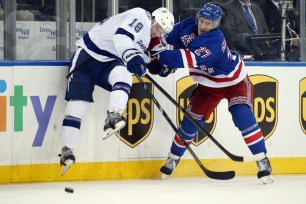 Ryan McDonagh of the Rangers holds off the Lighting's Ondrej Palat in the first period.