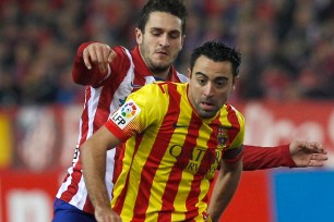 Barcelona midfielder Xavi Hernandez (front)