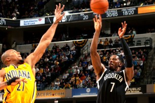 Johnson puts up a trey against the Pacers' David West.