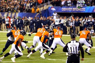 Peyton Manning chases after the ball on the safety that opened the game.