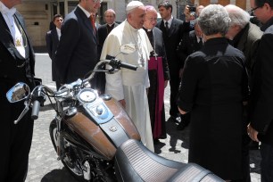 Pope Francis is presented with a Harley Davidson Dyna Super Glide motorcycle last June.