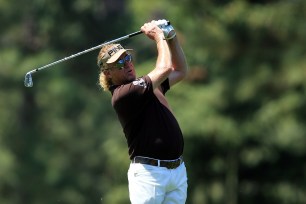 Miguel Angel Jimenez of Spain watches his approach shot on the 14th fairway during the third round of the 2014 Masters Tournament at Augusta National Golf Club on April 12, 2014 in Augusta, Georgia.