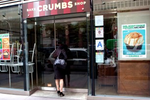 A would-be customer peers through the darkened windows of Crumbs at 3rd Avenue and 54th Street in Manhattan on Tuesday.