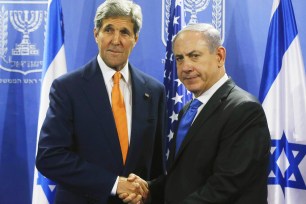 US Secretary of State John Kerry shakes hands with Israeli Prime Minister Benjamin Netanyahu in Tel Aviv on July 23, 2014.