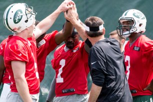Jets quarterbacks huddle up during training camp in July.